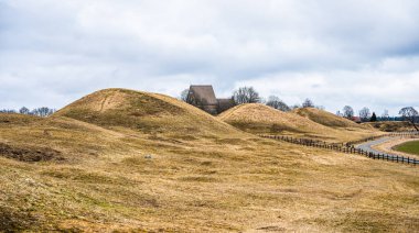 scenic view of rolling hills with a road and a church