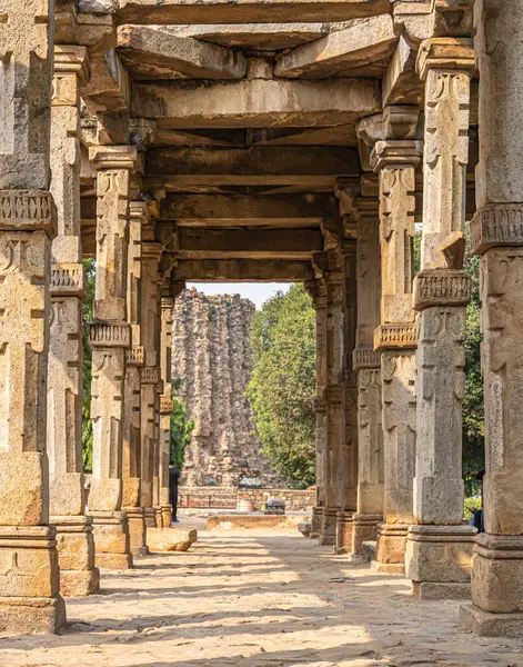 A walkway in the old Indian kutub minar complex. The vintage beams narrating the khalji dynasty history in India