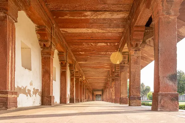 A walkway in the old Indian Taj Mahal complex. The vintage beams narrating the mughal dynasty history in India