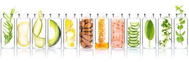 Homemade skin care with natural ingredients avocado ,aloe vera ,cucumber ,himalayan salt  ,honeycomb ,almonds, ginger slice and rosemary  in glass bottles isolate on white background.