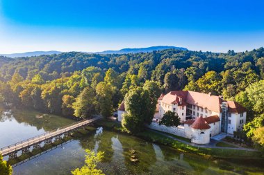 Slovenya 'daki Krka Nehri üzerindeki Otocec Kalesi' nin insansız hava görüntüsü ve ahşap köprü