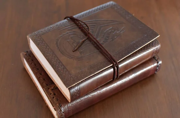 two handmade notebooks with leather covers