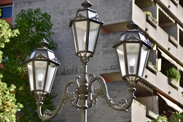 street lamp with 3 lamps near a residential building