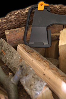 Hasır bir sepetin içinde odun ve balta.