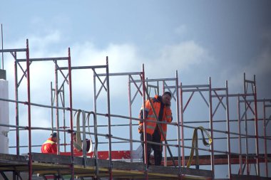 Berlin Almanya 04.24.2024, turuncu ceketli inşaatçılar bir ev inşaatında