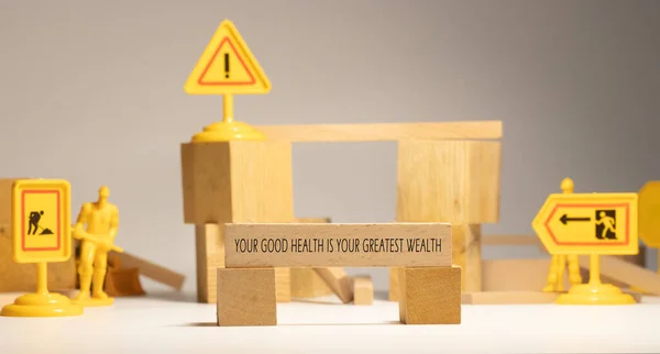 Your good health is your greatest wealth. Written on wooden surface