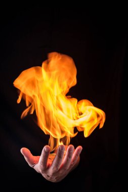 fireball on a male hand with black background