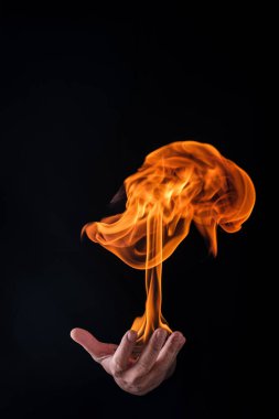 fireball on a male hand with black background
