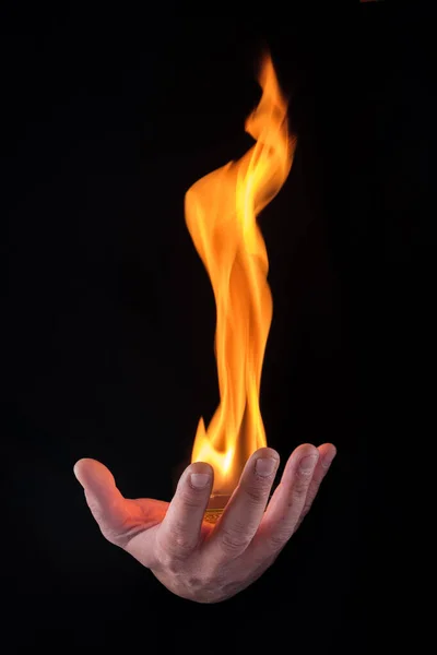 fireball on a male hand with black background