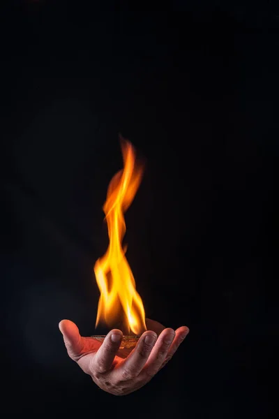 fireball on a male hand with black background
