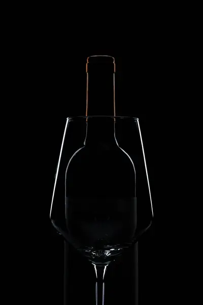 silhouette outline of wine glass and bottle on black background