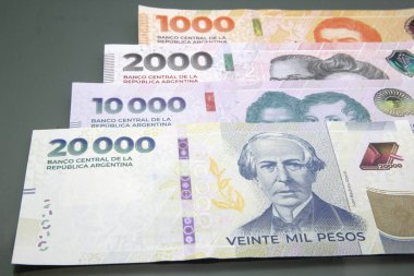 Argentine Money, Currency of Argentine, Pesos argentinos. Stack of several Argentine pesos banknotes, thousand pesos cash bills on dark background, twenty thousand pesos cash bills clipart