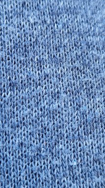 Ayrıntılı dikişleri, dokuyu ve deseni gösteren mavi örgü kumaşın yakın görüntüsü, tekstil ve tasarım kavramları için mükemmeldir.