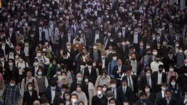 Tokyo, Japonya-12 Nisan 2023: İnsansız hava aracı birlikte yürüyen büyük kalabalığın havadan görüntüsünü yakalıyor ve kalabalık metropolün çeşitliliğini gösteriyor. Herkes koşuşturmaca ve kalabalık içinde ilerler.