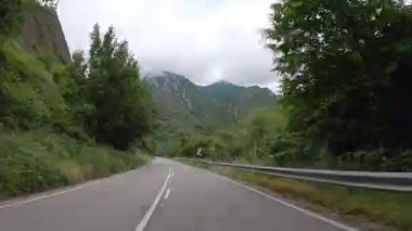Timelapse driving a car on empty regional road through the fields outside the city during sunny day in Spain. Countryside asphalt road landscape scene. Traveling concept