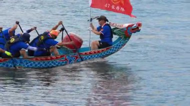 Taipei, Tayvan-08 Haziran 2024: Taipei kürekçisinin yavaş hareketi günbatımı ışığında küreği yavaşça kaldırması, göl ufkunun arkasında sakin bir hareket.