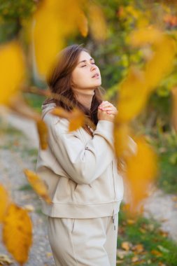 Genç kadın sonbahar yolunda duruyor ve ellerini kavuşturup Tanrı 'ya dua ediyor. Ruhunu, konsept dini ve yaşam tarzını döküyor.