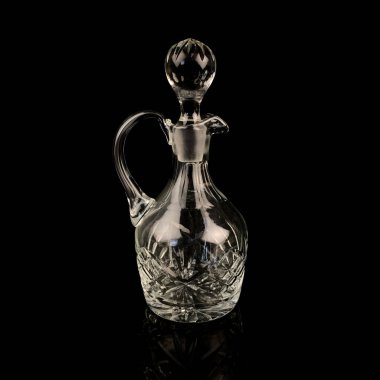 Geometrik desenli antika cam sürahi. Siyah izole edilmiş arka planda alkolün retro sürahisi. Oymalı vintage sürahi