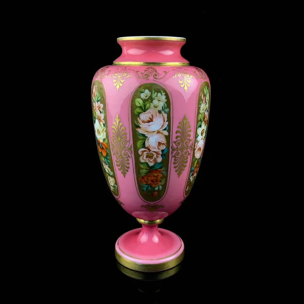 antique pink amphora with a floral pattern on a black isolated background. antique porcelain painted pink vase. hand painting