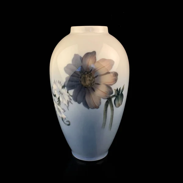 beautiful blue vase with a flower pattern on a black isolated background. antique porcelain vase with painting