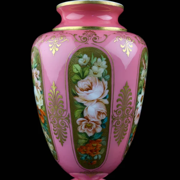 antique pink amphora with a floral pattern on a black isolated background. antique porcelain painted pink vase. hand painting