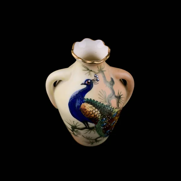 unusual vase with the image of a firebird on a black isolated background. antique porcelain vase with painting. firebird drawing