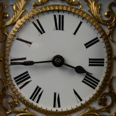 Antique gold watch in a leather box isolated on a black background. Antique clock with gold pattern. vintage clock close-up