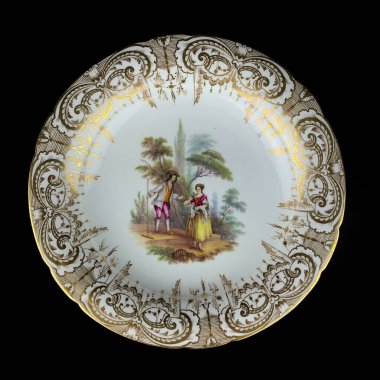 Porcelain plate on a black background, close-up. Round picture for decoupage.