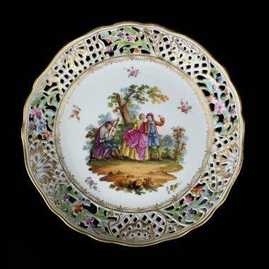 Porcelain plate on a black background, close-up. Round picture for decoupage.