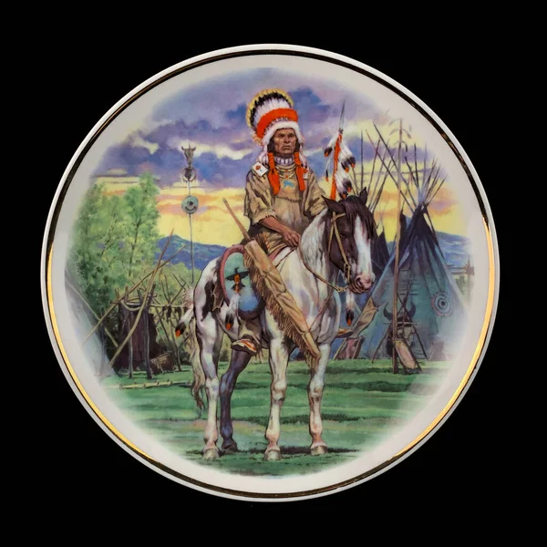 Native american indian chief on a round plate isolated on black. Round picture for decoupage.
