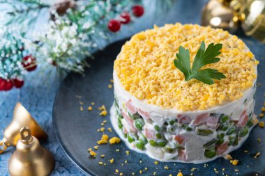 Mavi yüzeydeki Noel yemeği için Rus salatası veya Olivier salatası