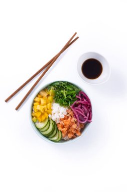 Poke bowl with rice, salmon,cucumber,mango,onion,wakame salad, poppy seeds ands sunflowers seeds isolated on white background