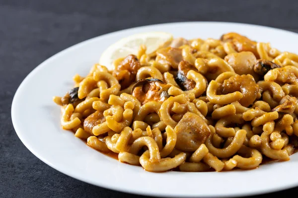 stock image Traditional Spanish fideua. Noodle paella on black background