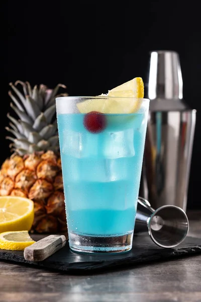 Deep blue sea martini cocktail on wooden table