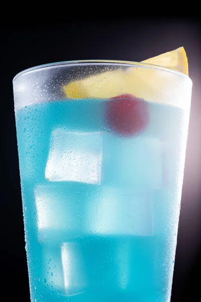 Deep blue sea martini cocktail on black background. Close up