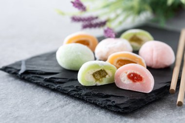 Japanese colorful mochi on gray stone surface clipart