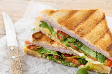 Jambonlu, peynirli, domatesli ve roka aromalı sandviç.