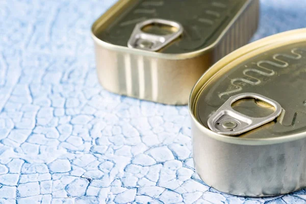 Canned food in metal can on blue background