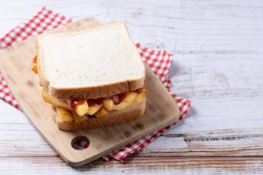 Geleneksel İngiliz cipsi Butty (patates kızartması sandviçi) ahşap masada.