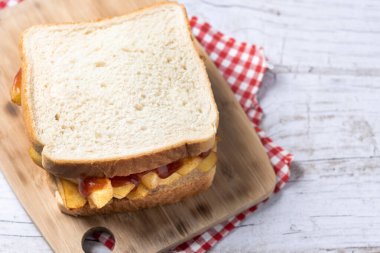 Geleneksel İngiliz cipsi Butty (patates kızartması sandviçi) ahşap masada.