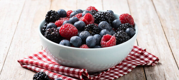 Fresh assortment berries on wooden table