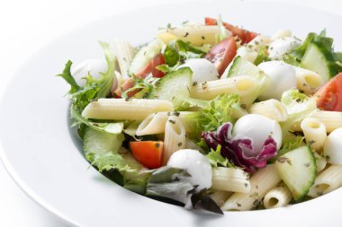 Pasta salad with vegetables and mozzarella cheese isolated on white background