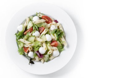 Pasta salad with vegetables and mozzarella cheese isolated on white background