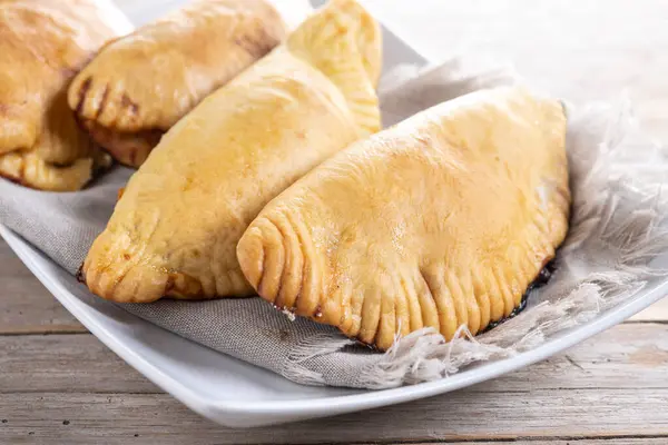 stock image Pumpkin empanadillas for Halloween or Thanksgiving's Day on wooden table