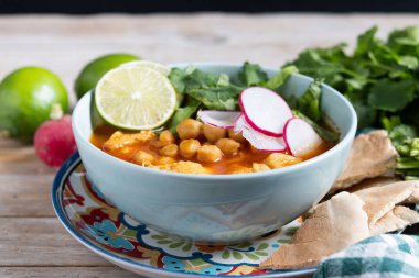 Geleneksel Meksika kırmızı pozole çorbası ahşap masada.