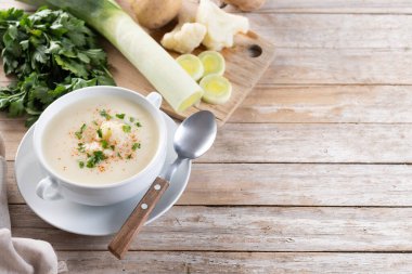 Karnabahar çorbası ahşap masada kasede. Boşluğu kopyala