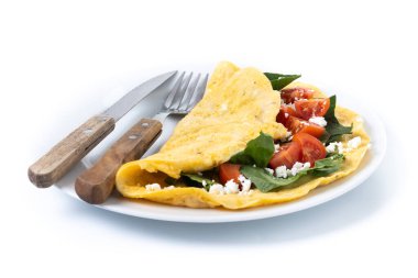 Beyaz arka planda domatesli ve ıspanaklı omlet.