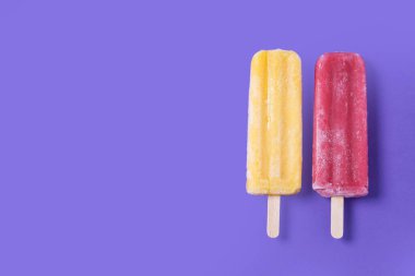 Mor arka planda limon ve çilekli dondurma. Üst Manzara. Boşluğu kopyala