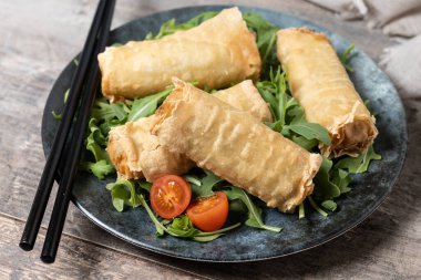 Çıtır çıtır sebzeler Tahta masada yuvarlanıyor