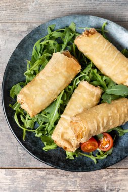 Çıtır çıtır sebzeler Tahta masada yuvarlanıyor